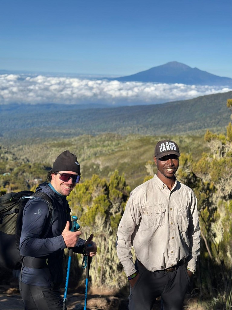 Godfrey Baltazary Lyimo guiding a guest above the clouds in Tanzania